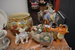 A selection of ceramics amongst which are a planter and elephant ornaments.