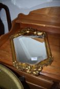 A hallway mirror having gilt wood carved frame