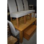 A modern beech effect kitchen table and set of five chairs