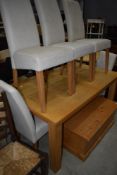 A modern beech effect kitchen table and set of five chairs