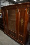 A large continental empire style book case with ormolu details and lion feet