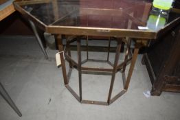 A glass top brass octagon table of geometric form, width approx 96cm