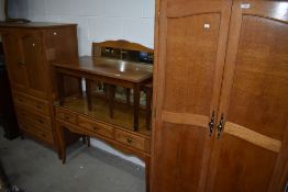 A golden oak bedroom suite including wardrobe dressing table and tall boy