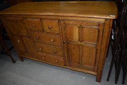An early to mid 20th Century golden oak sideboard, possibly early Ercol