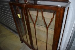 An art deco glass fronted display case