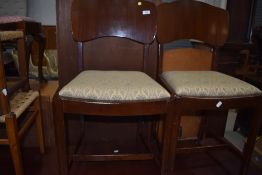 A pair of vintage ply back dining chairs