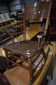 A traditional stained frame rocker having turned frame and partially carved back