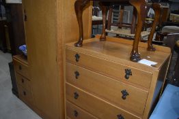 An early to mid 20th Century golden oak and ply two piece bedroom suite comprising single robe