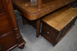 A 1930s Deco style walnut dining table of typical curved form