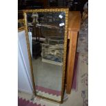 A gilt frame full length wall mirror