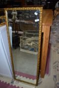 A gilt frame full length wall mirror