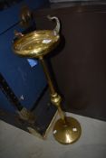 A vintage brass smokers stand