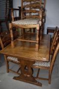 An extendable oak dining table and set of six matching chairs