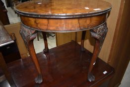 An early to mid 20th Century walnut occasional/coffee table having shaped cabriole legs