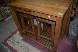 A modern beech kitchen island with two stools