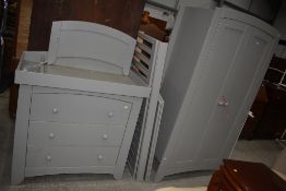 A modern grey painted nursery suite comprising wardrobe, changing drawers and cot
