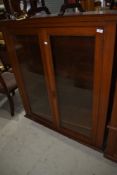 A mahogany cased glazed book shelf having rolled plate glass doors