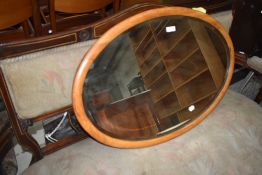 An oak oval wall mirror