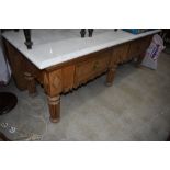 A traditional butchers block/dresser base having carved head ledge back and original wood and