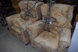 A pair of traditional wing back armchairs