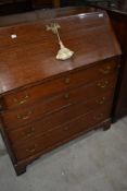 A period oak bureau having four long drawers and bracket feet