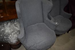 A pair of modern wing back armchairs in blue grey upholstery