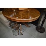 A reproduction Regency pedestal loo style table in light mahogany having oval top
