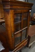 A small sized oak cased corner cupboard