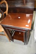 A nest of three mahogany tables