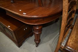 A Victorian wind out mahogany dining table on carved legs