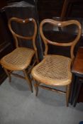 A pair of yellow pine balloon back bedroom chairs