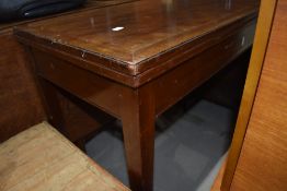 An early 20th Century fold over card table, in need of restoration, no inset to top