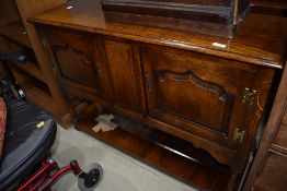 An oak sideboard of small proportions with under shelf