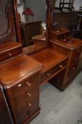 A Victorian desk style dressing table with drawer sides and carved mirror back