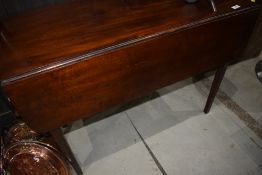 A 19th Century mahogany pembroke style table having frieze drawer and square tapered legs