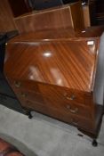 A mid 20th Century mahogany bureau on cabriole legs