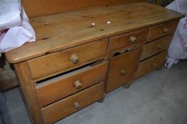 A Victorian style natural pine dresser base having ledge back