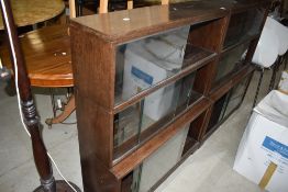 A pair of mid 20th Century dark oak stacking bookcases, minty or similar, each being three tiers ,