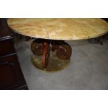 A large circular table having octopus style base with velvet lining