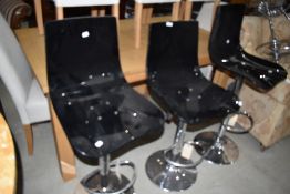 Three adjustable chrome kitchen stools