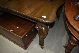 An extendable dining room table on cabriole legs