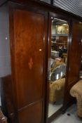 An Edwardian mahogany and inlaid mirror door wardrobe, width approx. 173cm