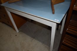 A vintage utility or kitchen table with blue formica top