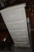 A modern laminate tall chest of drawers