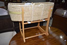A traditional moses basket on rocking cradle