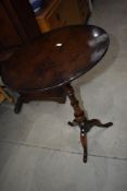 A mid Victorian wine or tea table on turned frame