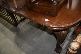 An extendable mahogany dining table