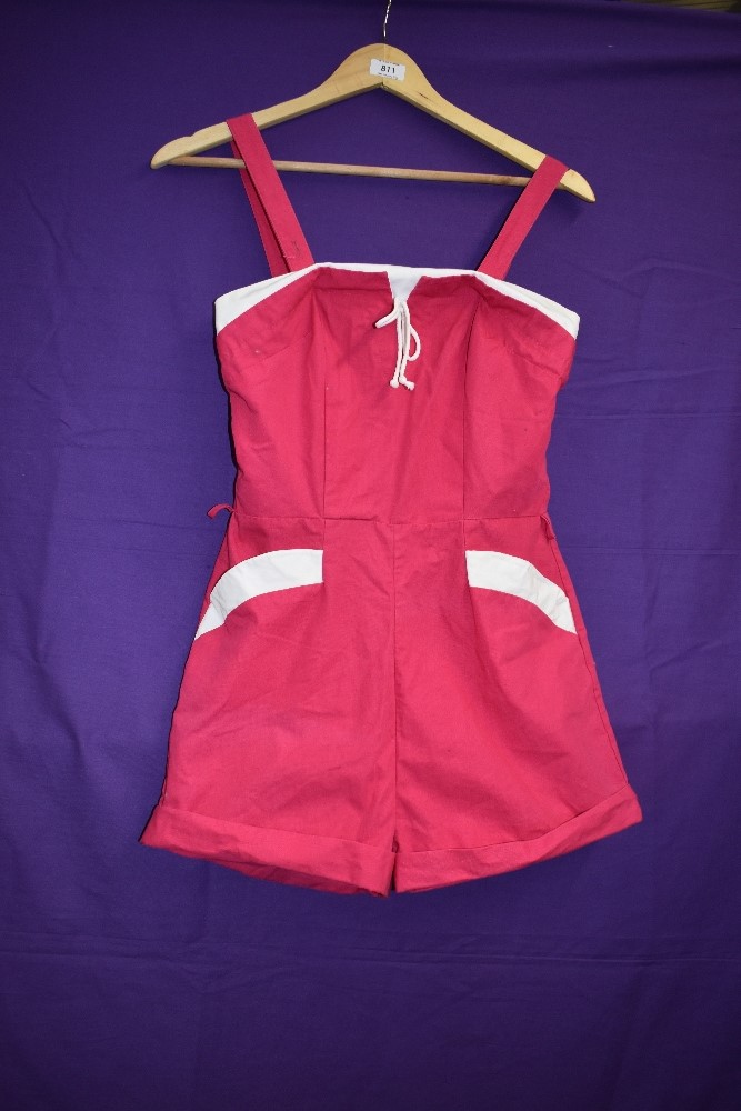 A 1950s Cerise and white cotton playsuit having pockets to front and button fastening to back.