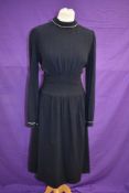 A 1930s navy blue wool day dress having long sleeves and turn down collar with white piping