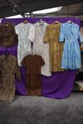 Six ladies vintage and retro dresses and a blouse, medium sizes, mixed styles.